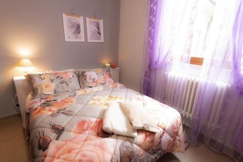 een slaapkamer met een bed en een raam met gordijnen bij Appartamento MARISOL Grazioso e vicino al mare in Porto SantʼElpidio