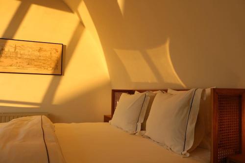 a bedroom with a bed with white pillows at The View in Antwerp