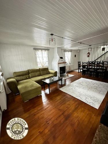 a living room with a couch and a table at Wood House Valiug in Văliug