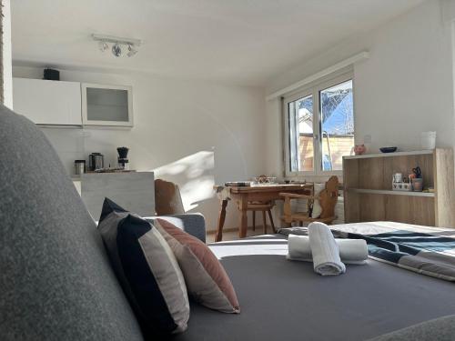 a bedroom with a bed with pillows and a table at Chasa Stefania, modernes Engadiner Haus mit Wellness und Sauna in Scuol