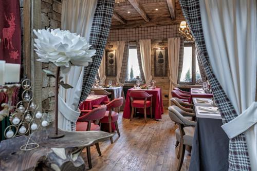 a restaurant with tables and chairs and a large white flower at Chalet BRAGARD in Limone Piemonte