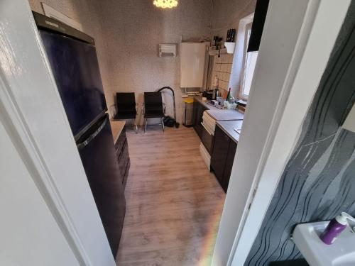 a small kitchen with a sink and a refrigerator at Ferienwohnung Plötzky in Plötzky