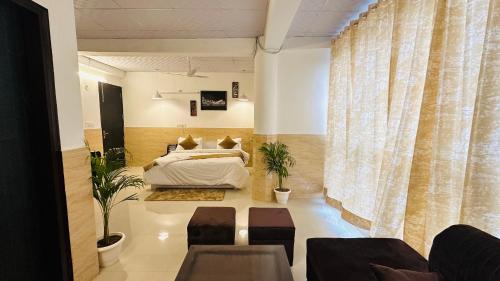 a bedroom with a bed and a large window at Hotel Relax In - Noida Sector 18 in Noida