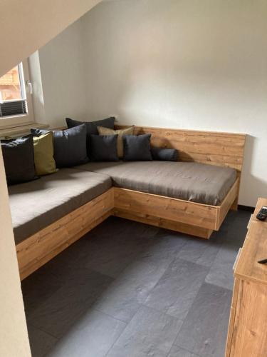 a wooden couch sitting in a living room at Berghof Geisler in Finkenberg
