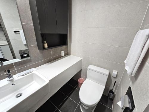 a bathroom with a white toilet and a sink at 라비앙즈-Raviens-Elliy's Room in Busan