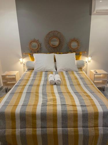 a bedroom with a bed with two towels on it at Labellapose in Le Diamant