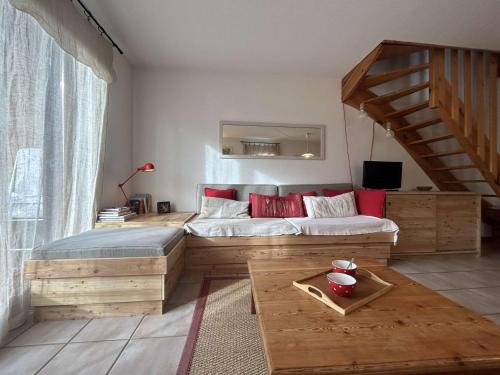 a bedroom with a large bed with red pillows at Appartement Le Monêtier-les-Bains, 3 pièces, 6 personnes - FR-1-330F-36 in Le Monêtier-les-Bains