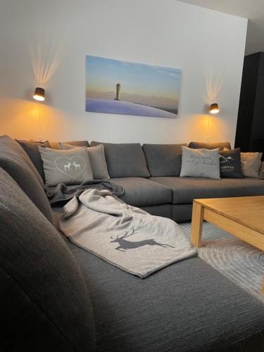 a living room with a couch with a t shirt on it at kleineauszeit3, Feldberg, direkt an Skipiste, mit Sauna in Feldberg
