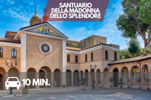 a building with a clock on the side of it at Seafront House Free Parking AC in Alba Adriatica