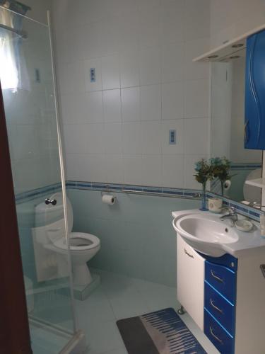 a bathroom with a toilet and a sink at SeyBreeze Villa in Anse Royale