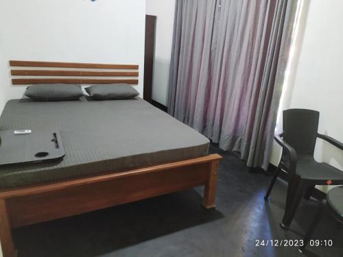 a bedroom with a bed and a desk and a chair at Digital Nomads in Weligama