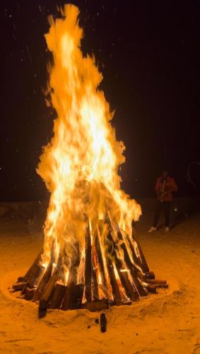 a large bonfire on the beach at night at Divine Resort & Spa in Kampala