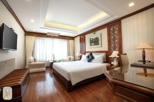 a hotel room with a bed and a television at Thien Thai Hotel & Spa in Hanoi