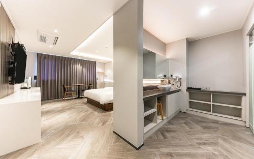 a hotel room with a bed and a desk at H Avenue Gyeongju Bulkuk temple in Gyeongju