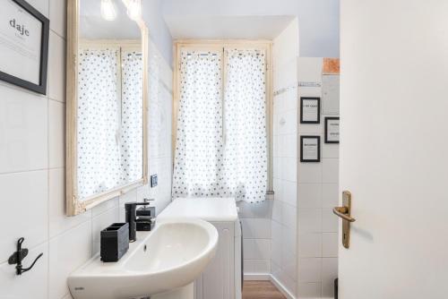 y baño blanco con lavabo y ducha. en Trastevere Stylish, en Roma