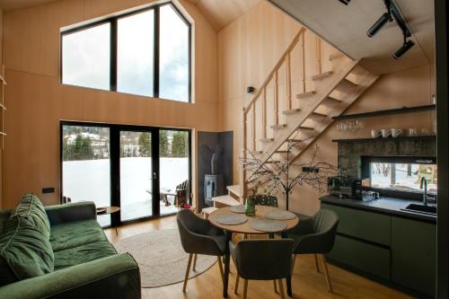 a kitchen and living room with a table and chairs at Tysha in Tatariv