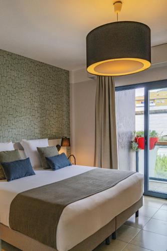 a bedroom with a large bed and a large window at Hotel Benahoare in Los Llanos de Aridane