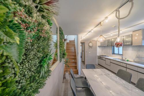 a kitchen with a green wall with a table and chairs at 2 shower rooms #Shinjuku 5 min walk from station ,projector in Tokyo