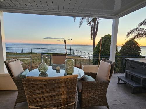 a table and chairs on a patio with a view of the ocean at intercomerciofeja Experiencia de Lujo in Benalmádena