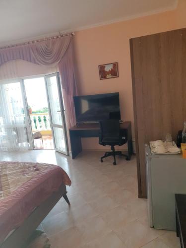 a bedroom with a bed and a desk and a piano at SeyBreeze Villa in Anse Royale