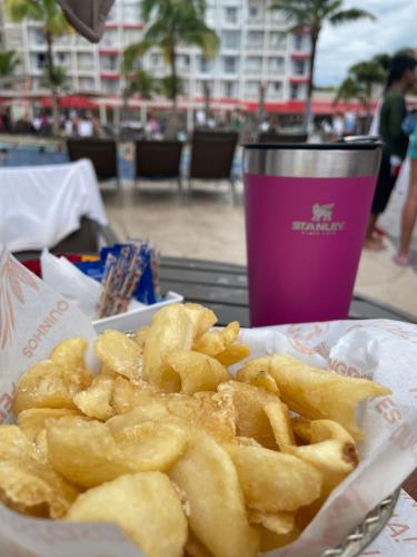 a basket of french fries and a cup of coffee at Enjoy Thermas de São Pedro in São Pedro