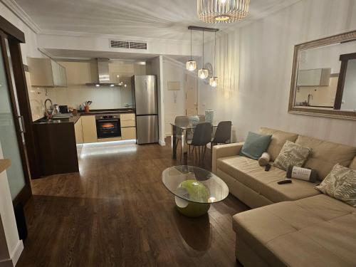 a living room with a couch and a table at intercomerciofeja Experiencia de Lujo in Benalmádena