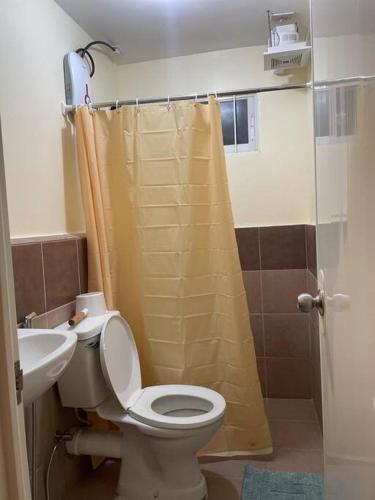 een badkamer met een toilet, een wastafel en een douche bij Casa Teresita: 1Br Unit @ Arezzo in Davao City