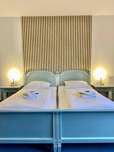 a large blue bed with two pillows on it at Gästehaus Weserblick am Weser-Sandstrand in Berne