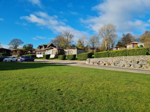 a driveway in a residential neighborhood with houses at Sherwood 33 in Carnforth