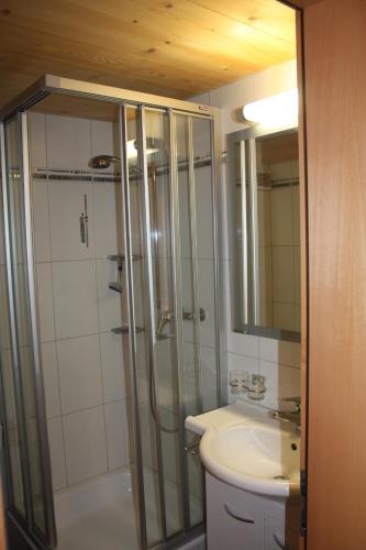 a bathroom with a shower and a sink at Alphütte Bielerhüs in Fiesch