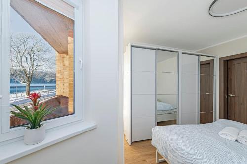 a bedroom with a bed and a window with a view at Riverfront 1BD Old Town Apartment by Hostlovers in Kaunas