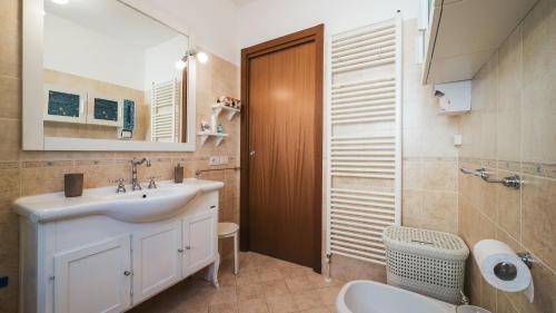 a bathroom with a sink and a toilet at Casa Gioia a 5 minuti da San Marino in Montescudo