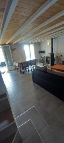 a living room with a table and chairs in a room at Gîtes de la vallée des gaves in Préchac