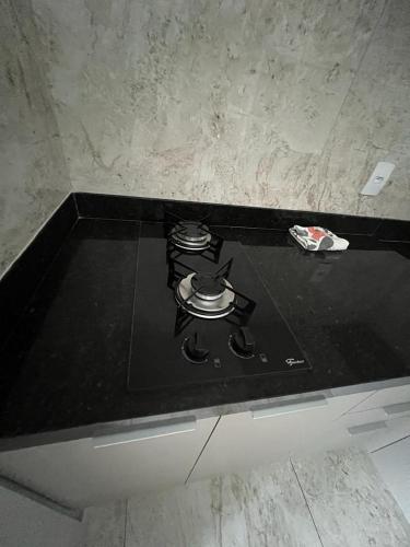 a stove top with a pot on top of it at Residencial Cristina Pinto in Campina Grande