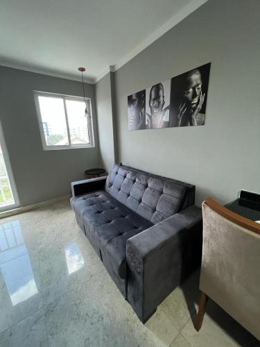 a living room with a leather couch in the corner at Residencial Cristina Pinto in Campina Grande