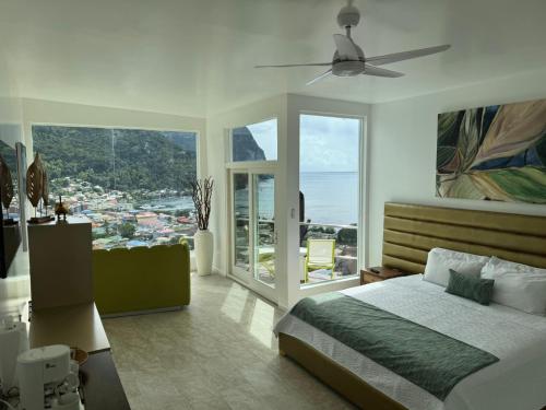 a bedroom with a bed and a ceiling fan at Green Fig Resort & Spa in Soufri&egrave;re