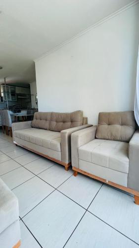 two couches sitting in a living room at Ocean Atlantic Praia de Iracema in Fortaleza