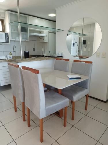 a kitchen with a white table and chairs at Ocean Atlantic Praia de Iracema in Fortaleza