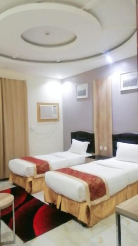 2 Betten in einem Hotelzimmer mit einer Decke in der Unterkunft شقق روز شروره للشقق المخدومة in Sharorah