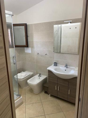 a bathroom with a sink and a toilet at Ruben holiday in Palinuro