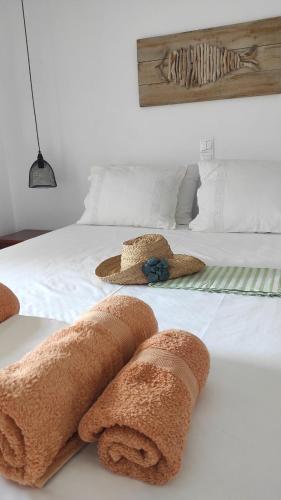 a bedroom with a bed with towels on it at Zaira Studios in Skala Eresou