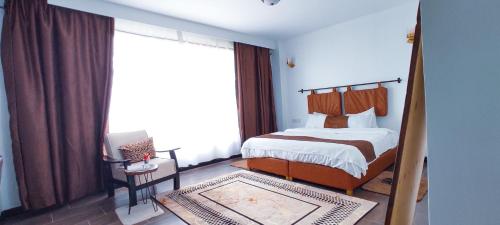 a bedroom with a bed and a large window at Top Tier Home in Nairobi