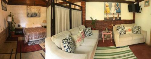 a living room with a couch and a bed at La casa de arturito in Santa Lucía