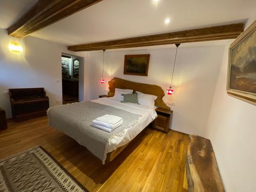 a bedroom with a bed with two towels on it at Casa IEUD - CĂTUN in Sinaia