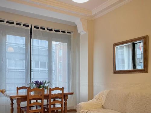 a living room with a table and chairs and a window at Bois Argentine by ARoom VUT-LE-1079 in León