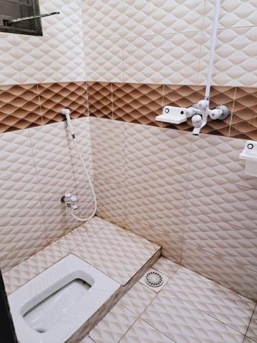 a bathroom with a toilet and a sink at Lord Family Hotel in Lahore