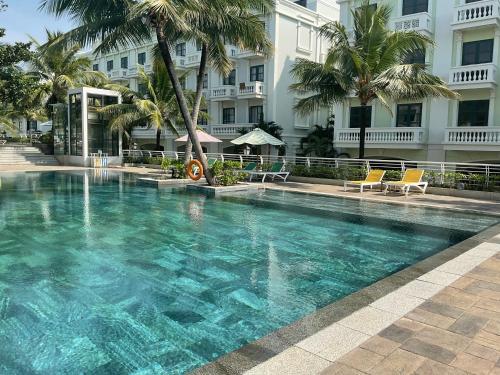 a large swimming pool in front of a building at Green Inn Phu Quoc Hotel in Phu Quoc