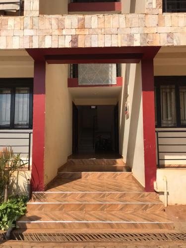 una entrada a un edificio con paredes rojas y blancas en cozyhome256, en Kampala