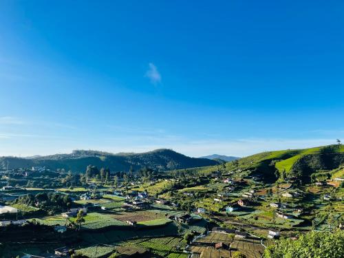 an aerial view of a village in the hills at Cabin 7000 feet Nuwaraeliya in Nuwara Eliya