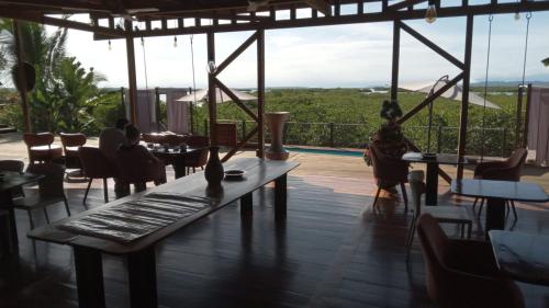 a restaurant with a table and chairs and a view at Villa F&B in Bocas del Toro